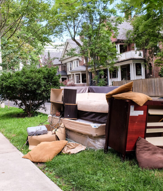 furniture-waiting-for-recycling-on-the-sidewalk-EMJ8YXL